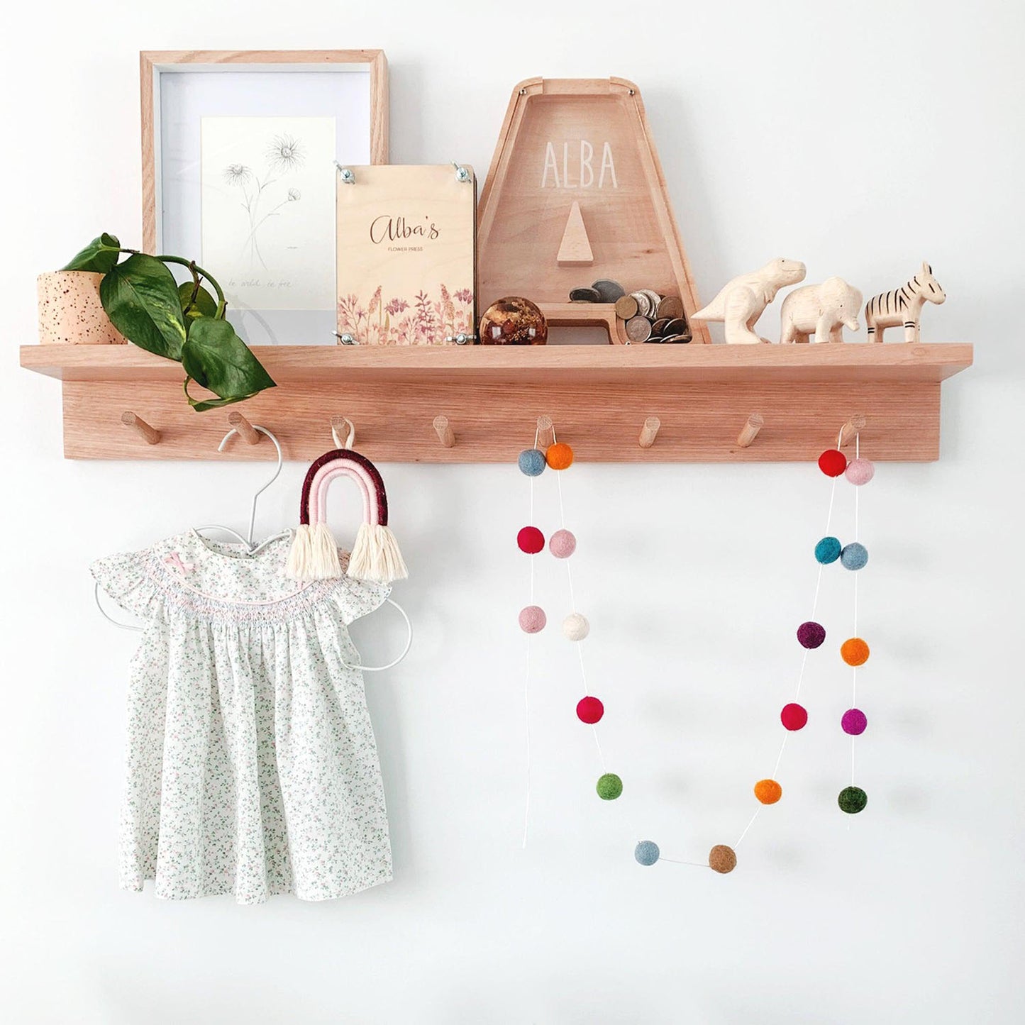 Charming Tasmanian Oak kids' wall mount coat rack and nursery shelf in a delightful bedroom setting, adding organized elegance to the space with Australian timber craftsmanship