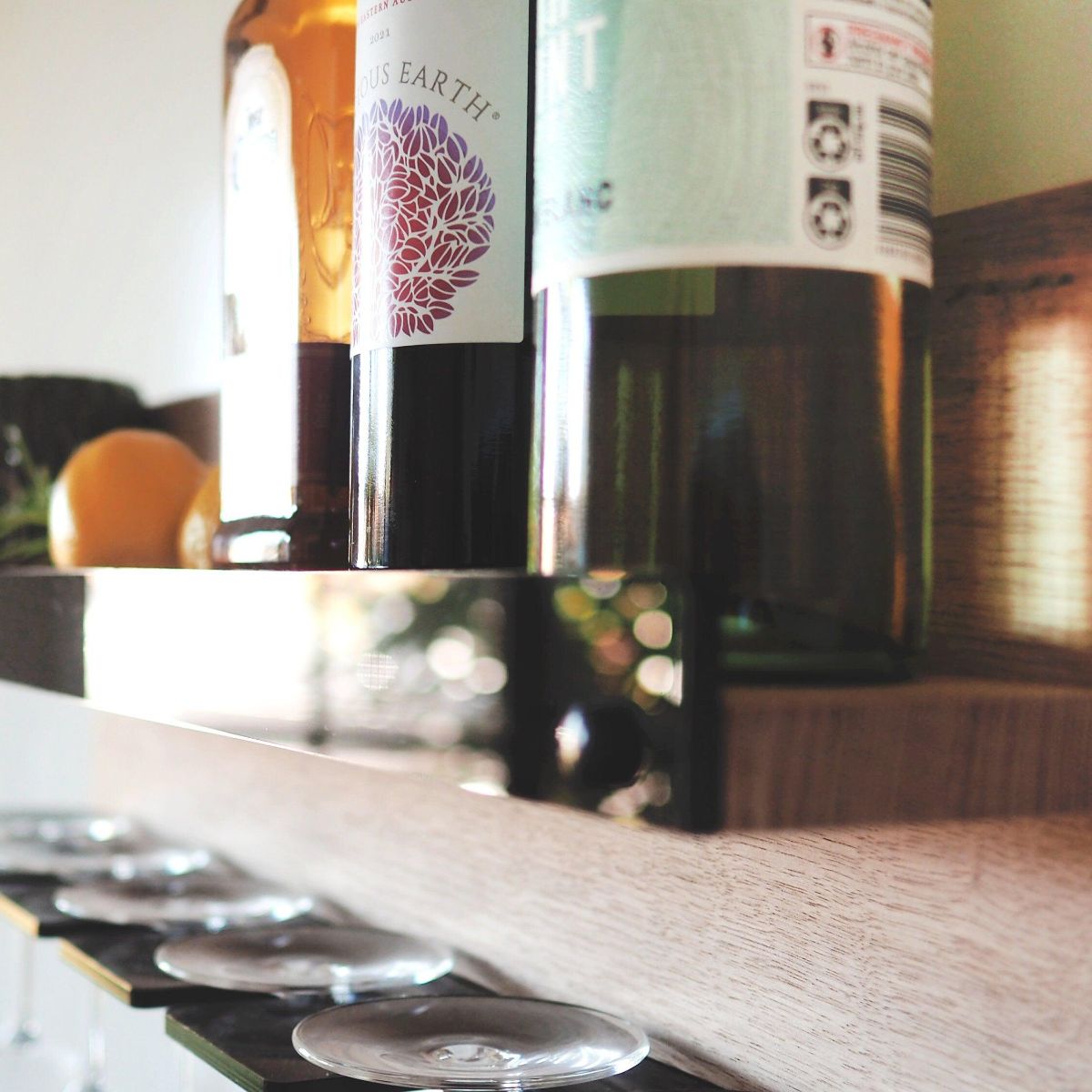 A shelf for wine glasses and wine/alcoholic beverages made from Tasmanian oak with a black acrylic front and holder