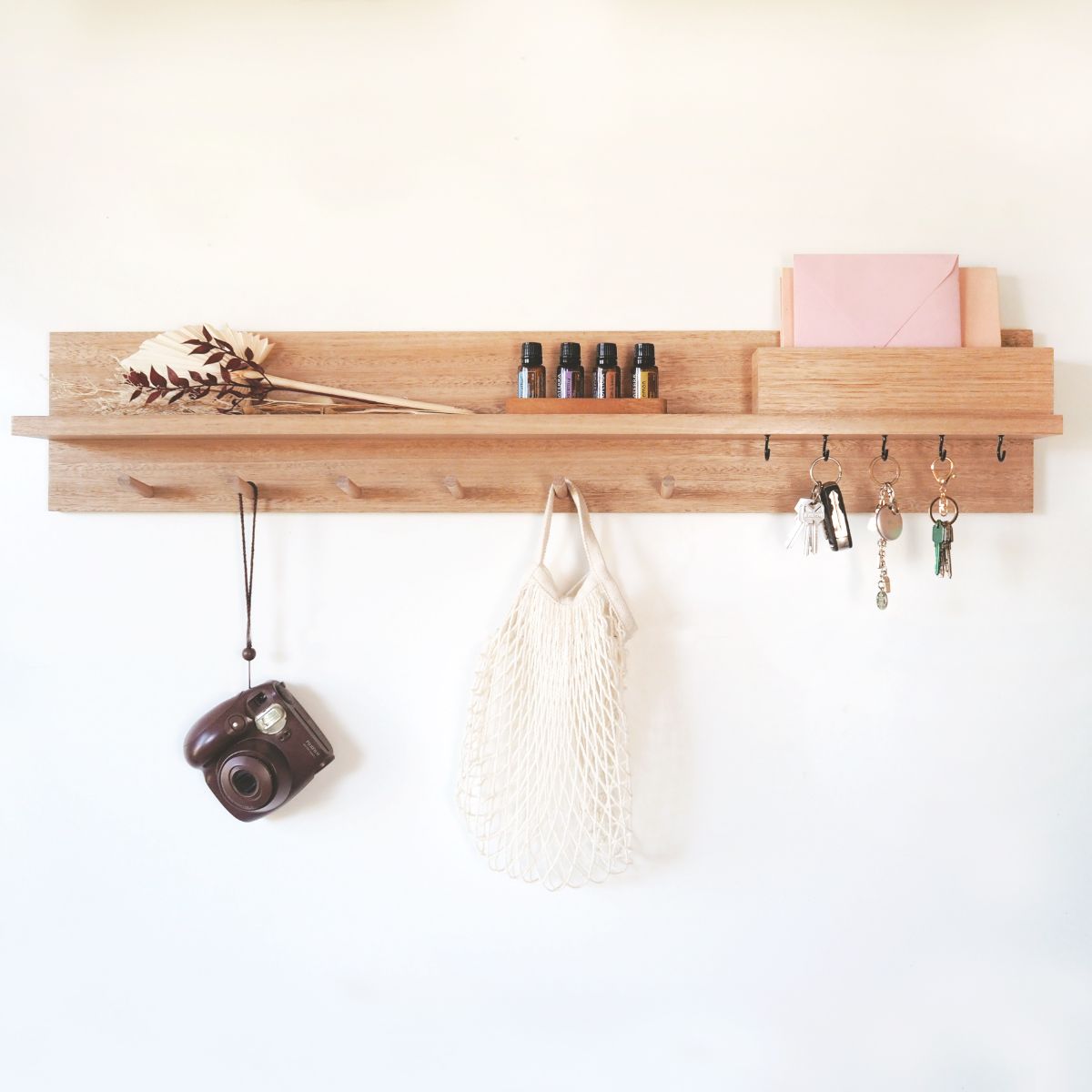 A 100cm Tasmanian Oak Entryway Shelf with mail holder, coat pegs and black hook key holders