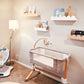 Several arch or scallop bookshelves in raw wood and white is in this baby's nursery room