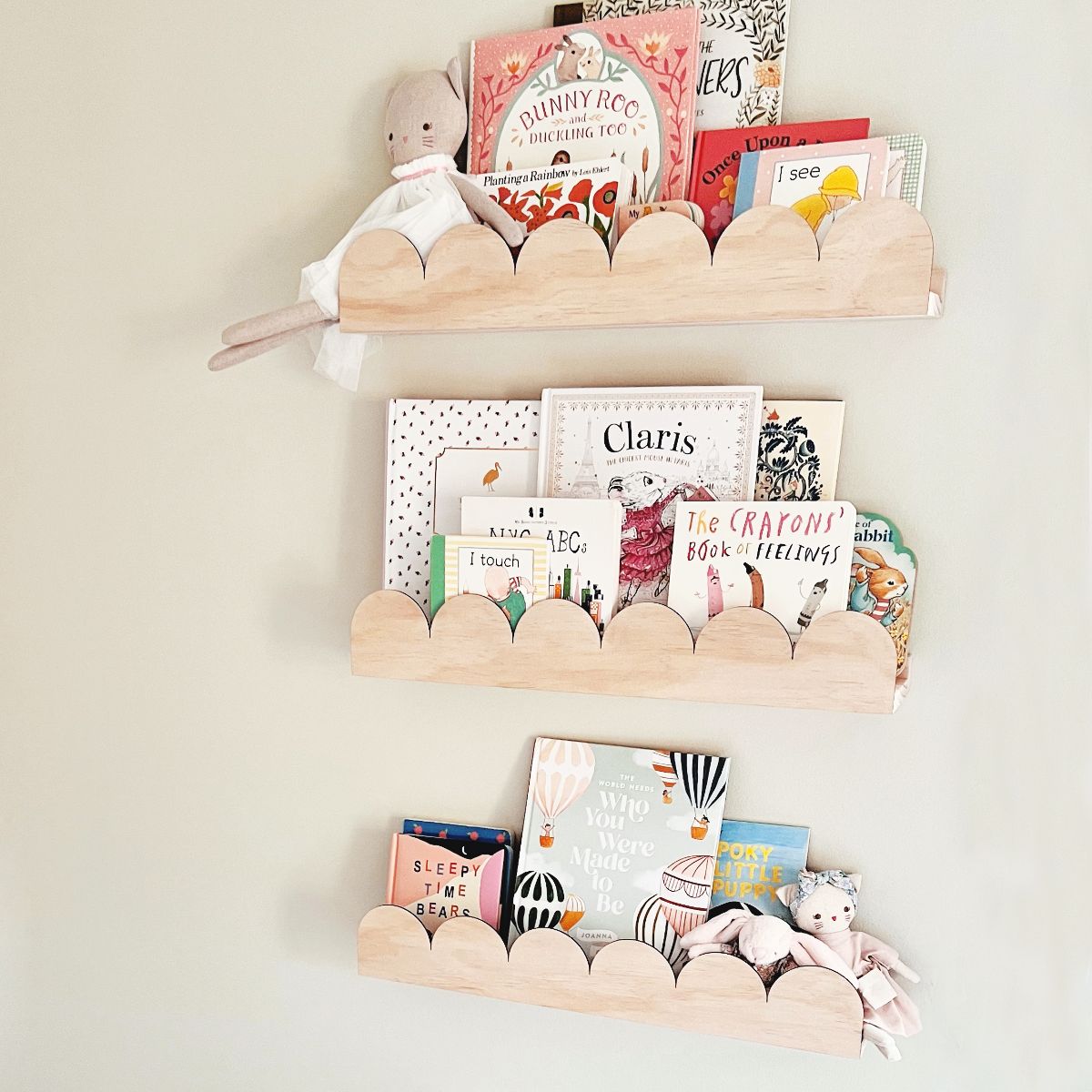 Featuring 3 pieces of the arch or scallop kids bookshelf with the child's favourite books and toys inside them