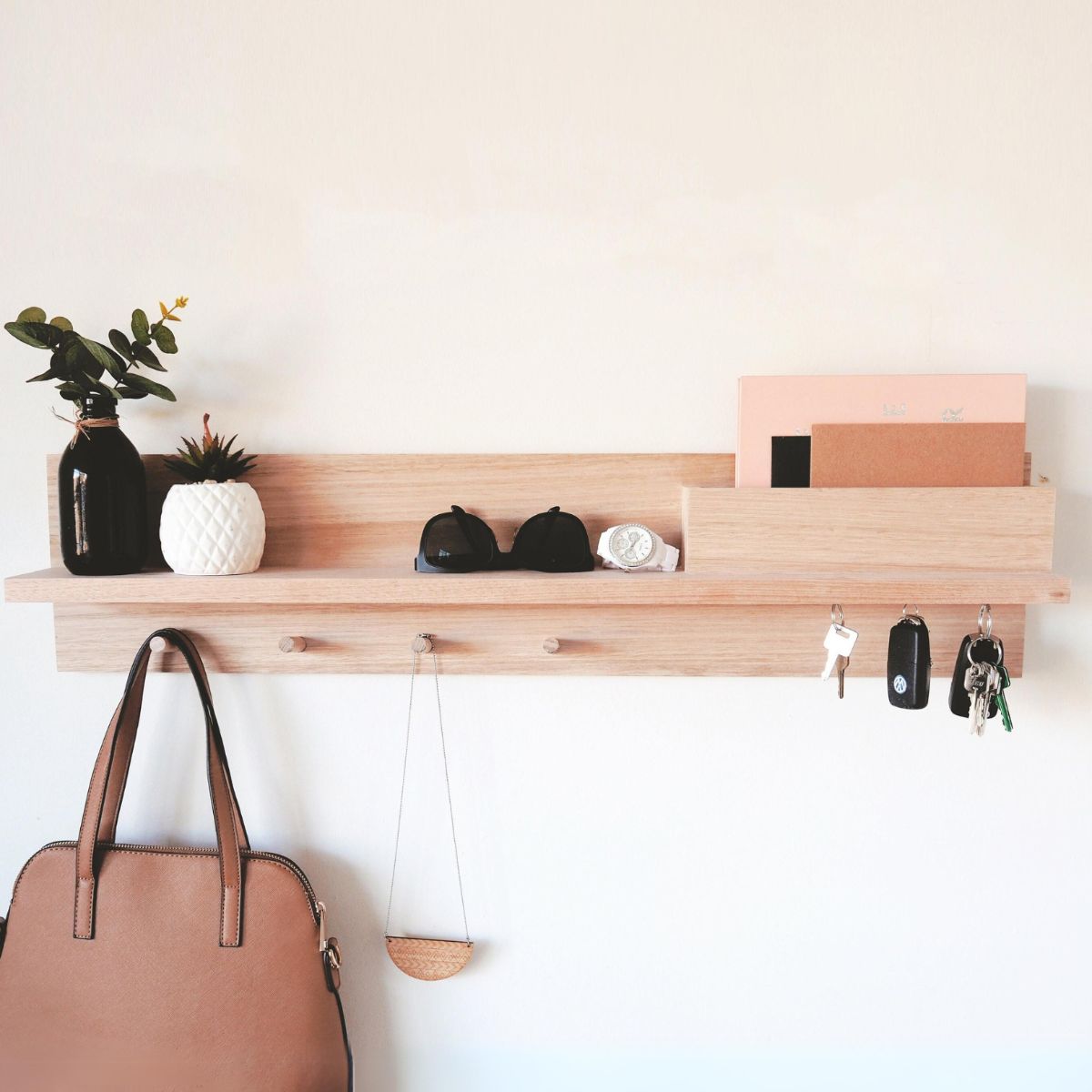 This is an 80cm Tasmanian Oak Entryway Shelf Organiser. Wall-mounted with mail holder, magnetic key holders, coat rack and shelf.
