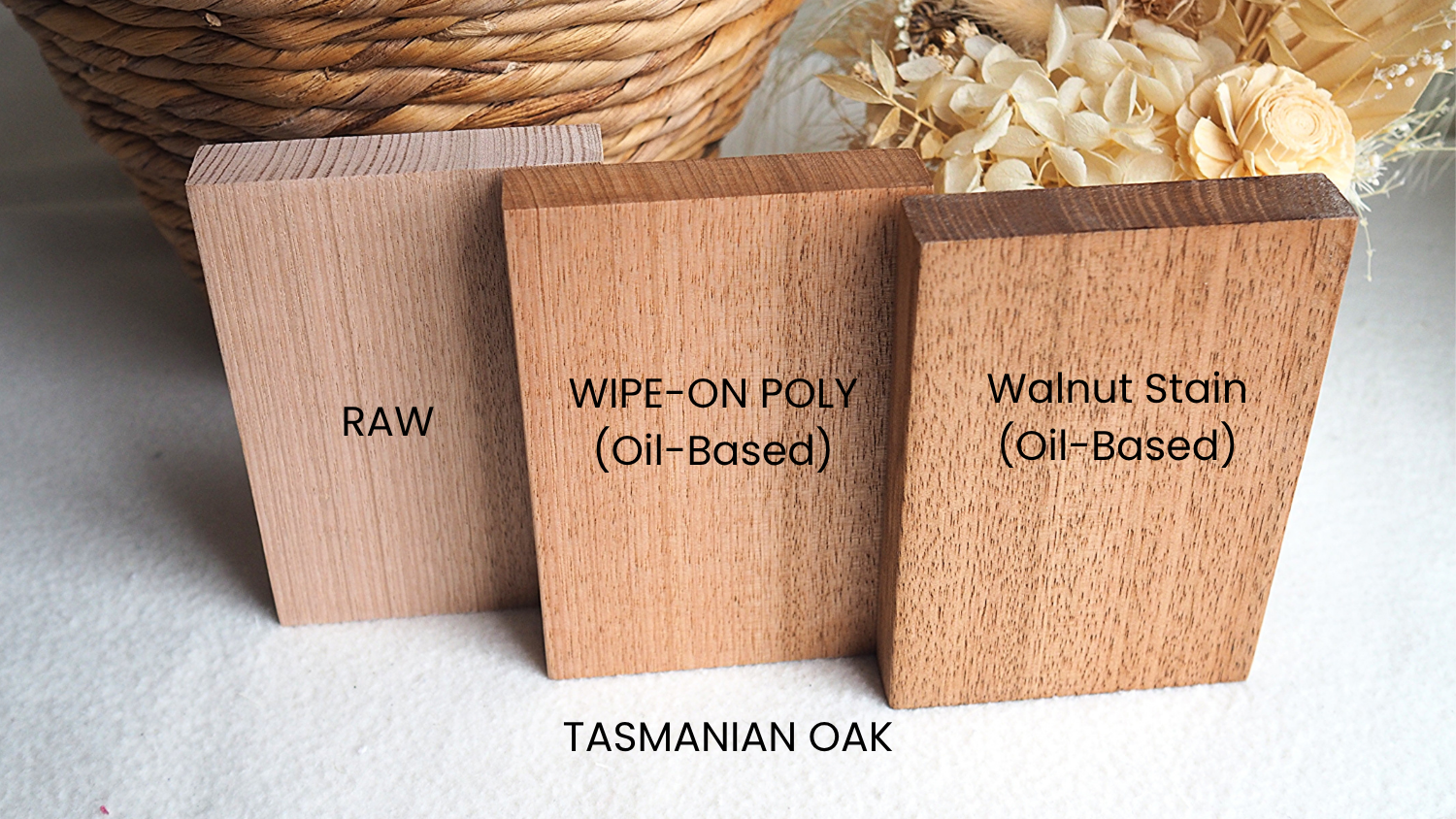 Three wooden samples labeled 'Raw', 'Wipe-On Poly (Oil-Based)', and 'Walnut Stain (Oil-Based)' on a textured surface.