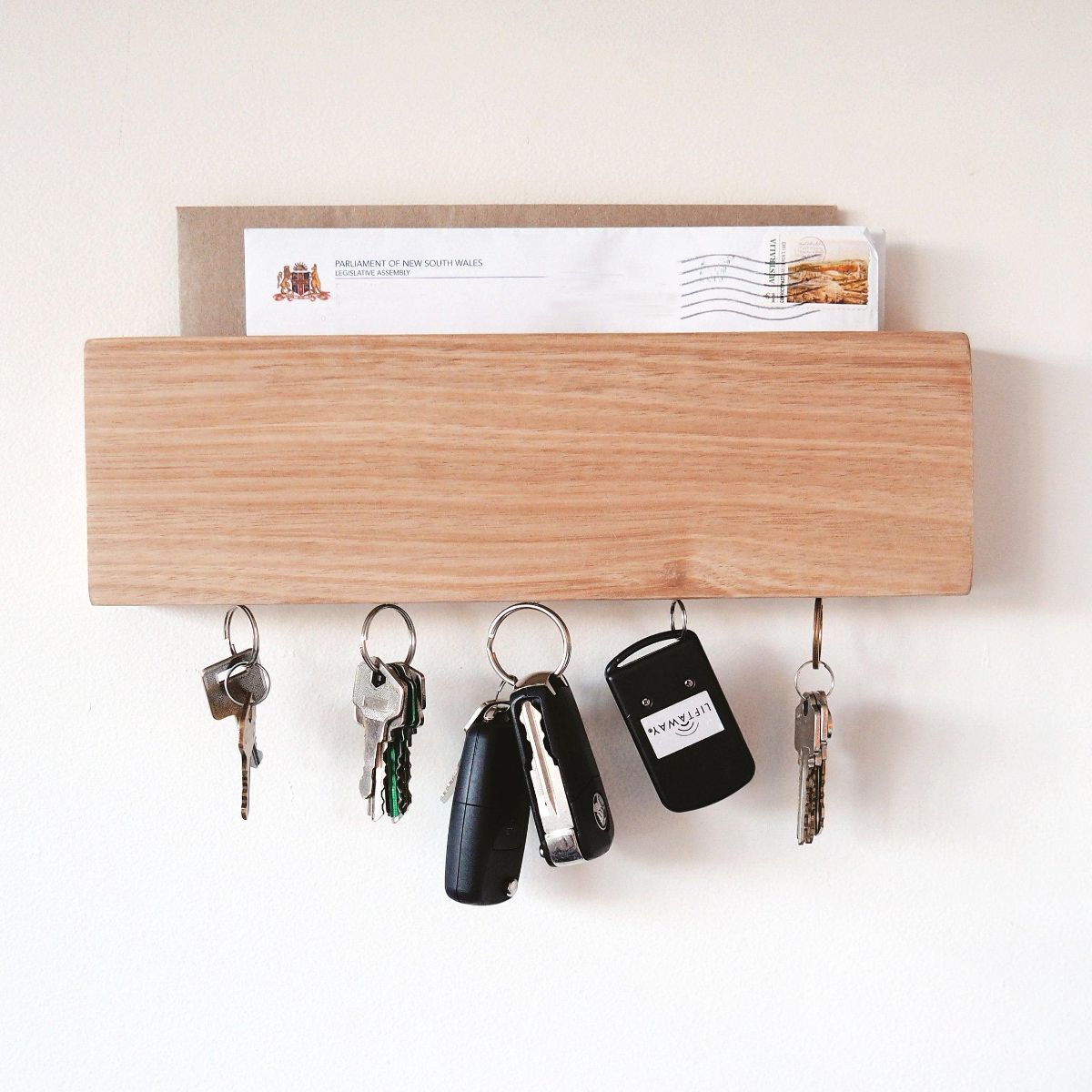 This is a wall-mounted mail and magnetic key holder for the entryway. Can be personalised for a great gift