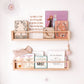 Two pine wood bookshelves filled with an assortment of books, adding a touch of rustic charm to the kids room's decor