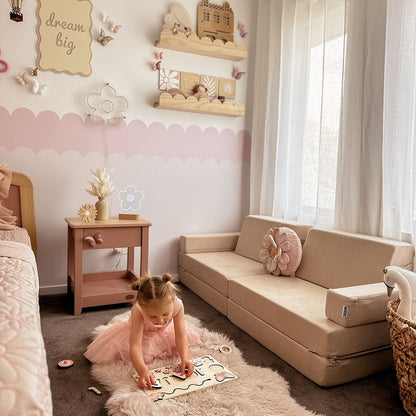 Child playing with a puzzle on a fluffy rug in a cozy bedroom with a wooden scallop bookshelf at this girl's room