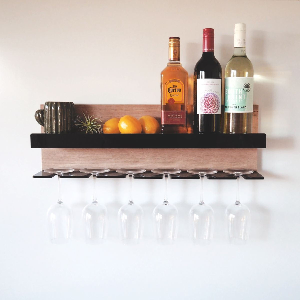 A shelf for wine glasses and wine/alcoholic beverages made from Tasmanian oak with a black acrylic front and holder