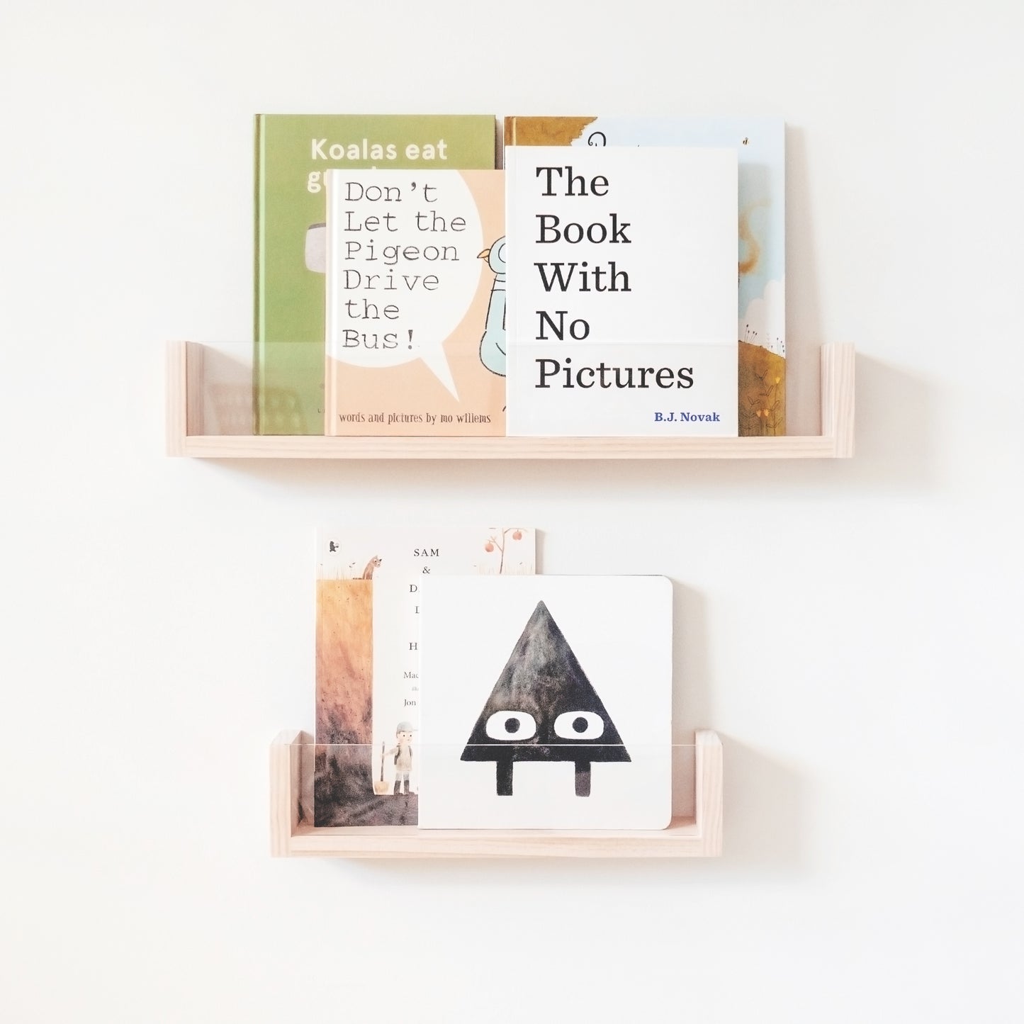 This item has a wooden shelf with clear acrylic in front. The books are stacked inside